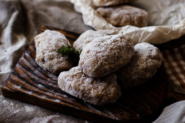 Cute little girl enjoying a homemade cooking holding a slice in her hand as she sits at the table looking at the camera with a smile