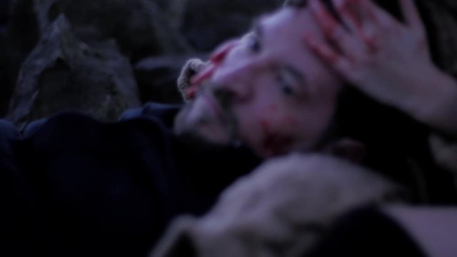 Vampire woman caressing dead boyfriend slow motion closeup of man