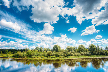 River Landscape With Reflections Of Clouds And Woods In Water. S