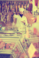 Fototapeta premium Male shop assistant demonstrating jamon