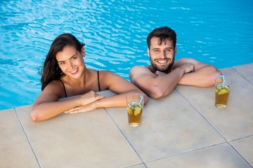 Portrait of young couple relaxing in the pool - Powered by Adobe