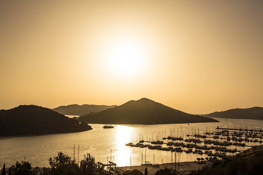 Fototapeta Sunset over the port with yachts. Turkey, Oludeniz.