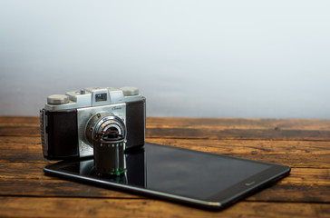 Vintage camera next to a tablet