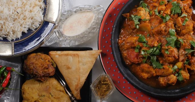 Dolly top down view of a delicious chicken tikka masala with Indian spices