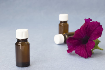 Three dark glass bottles on a grey background.
