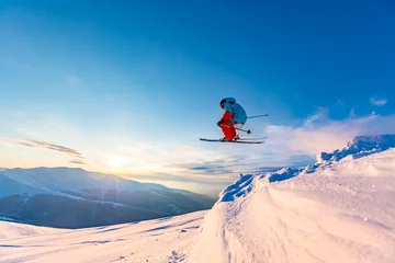 Fotobehang Good skiing in the snowy mountains, Carpathians, Ukraine. Beautiful winter sunset, incredible ski jump. © Taras