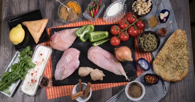 Stop motion of ingredients for chicken tikka masala with Indian spices