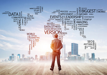 Motivation and inspiration concept with modern cityscape and businessman observing it
