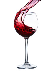 Red wine splashing in a glass
