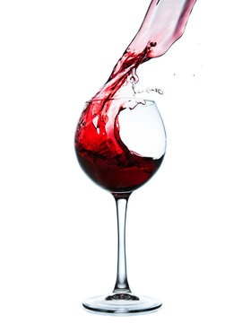 Red wine splashing in a glass
