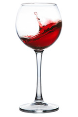 Red wine splashing in a glass