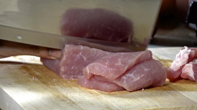 Raw pork cut into pieces to Cook on a wooden