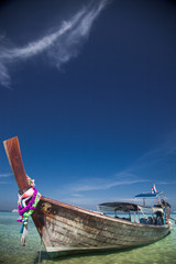 KO PHI PHI, THAILAND, February 2, 2014: Tropical beach with traditional long tail boats on the...