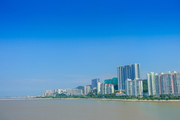 Fototapeta na wymiar Beautiful Macao city in the horizont with some modern buildings in a beautiful blue sky