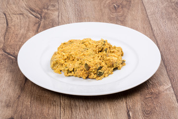 Vegetarian food on a plate with wooden background