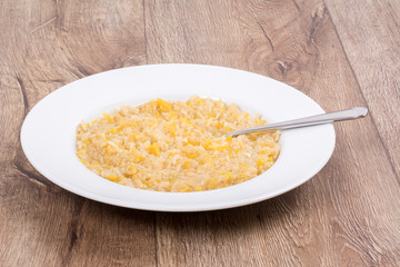 Vegetarian food on a plate with wooden background