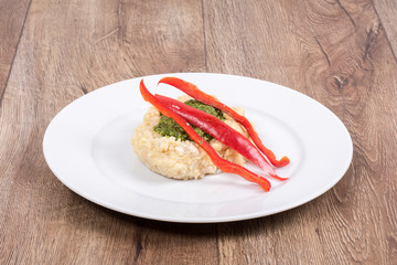 Vegetarian food on a plate with wooden background