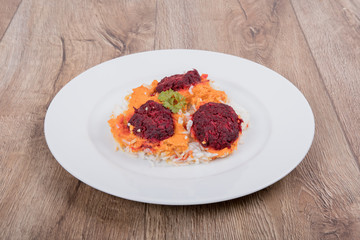 Vegetarian food on a plate with wooden background