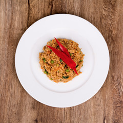 Vegetarian food on a plate with wooden background