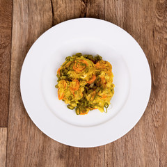 Vegetarian food on a plate with wooden background