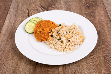 Vegetarian food on a plate with wooden background