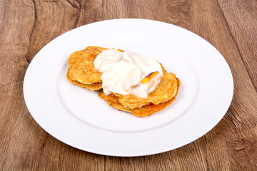 Vegetarian food on a plate with wooden background