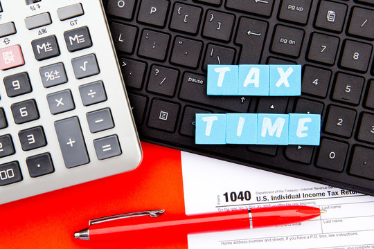 Tax Time - USA -  letters with 1040 Tax Form, calculator and keyboard
