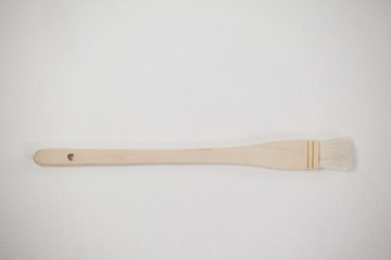 Flat paint brush against white background