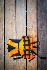 life vest on wooden ground