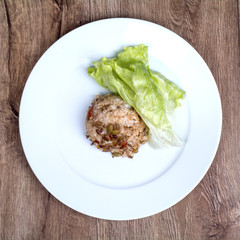 Vegetarian food on a plate with wooden background