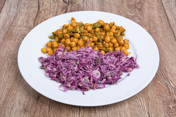 Vegetarian food on  plate with wooden background