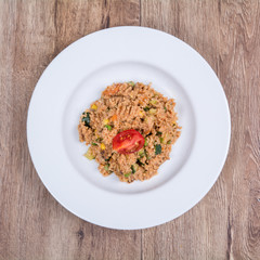 Vegetarian food on a plate with wooden background
