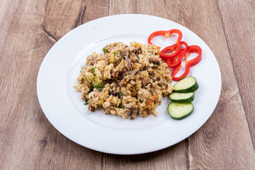 Vegetarian food on a plate with wooden background