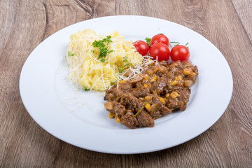 Vegetarian food on a plate with wooden background