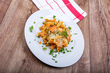 Vegetarian food on a plate with wooden background