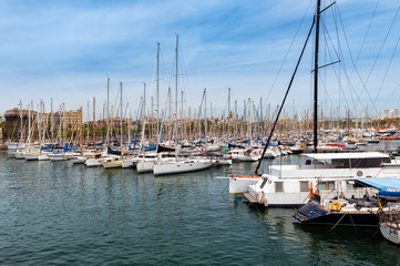 Fototapeta na wymiar Moored yachts at sea port of Barcelona town, Catalonia, Spain