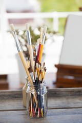 Set of paint brushes in a jar