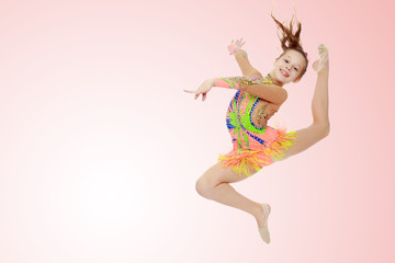 Girl gymnast performs a jump. © lotosfoto