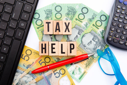 Tax Help - Australia - wooden letters with eyeglasses, money and calculator
