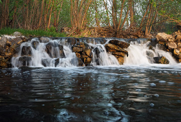 Obraz premium Waterfall at the sunset