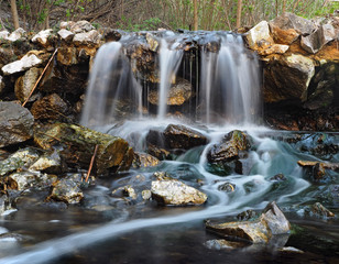 Waterfall at the sunset in forest stram
