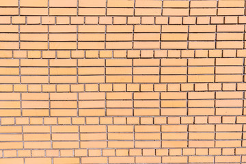 A wall of cracked bricks with fresh cement joints