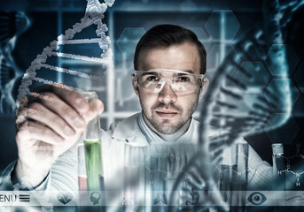 Young scientist mixing reagents in glass flask in clinical laboratory