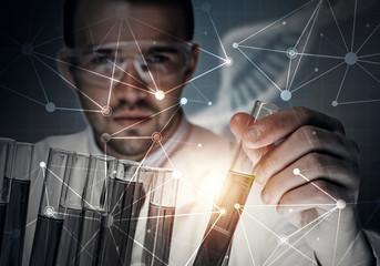 Portrait of concentrated male scientist working with reagents in laboratory