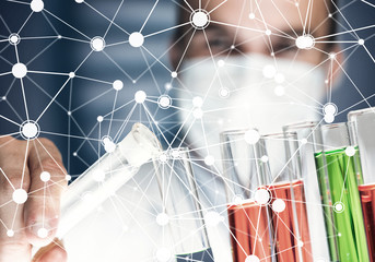 Portrait of concentrated male scientist working with reagents in laboratory