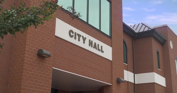 A daytime closeup establishing shot of a generic city hall building.	 	