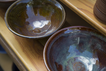 Isolated Right Angle Top View Point,  Fired Glazed Organic Earthenware Clay Ceramic Bowls on Wooden Shelf, Blues, Brown Tones, Daytime (HDR Image) Use Overlay as Space for Copy Text