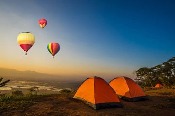 Colorful hot-air balloons flying over the mountain