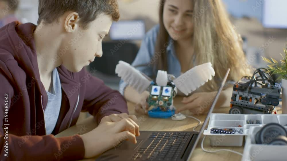 Aufkleber girl and boy program fully functional robot with laptop for their science/ robotic/ engineering clas