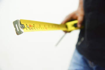 hand holding measuring tape over white background